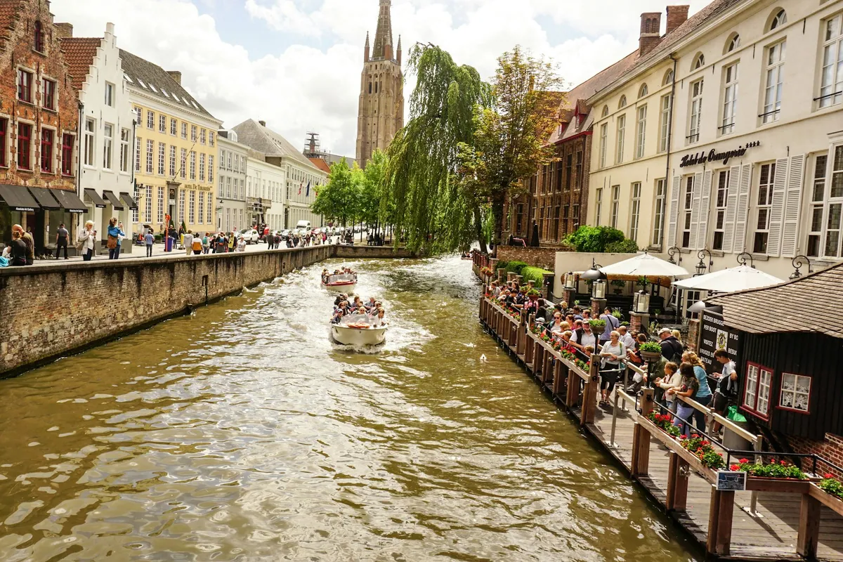 A guided sightseeing boat on a central Bruges canal