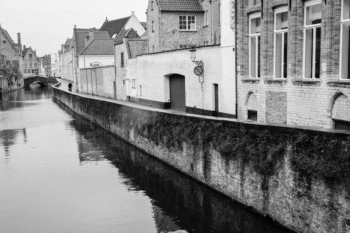 A cyclist riding through central Bruges