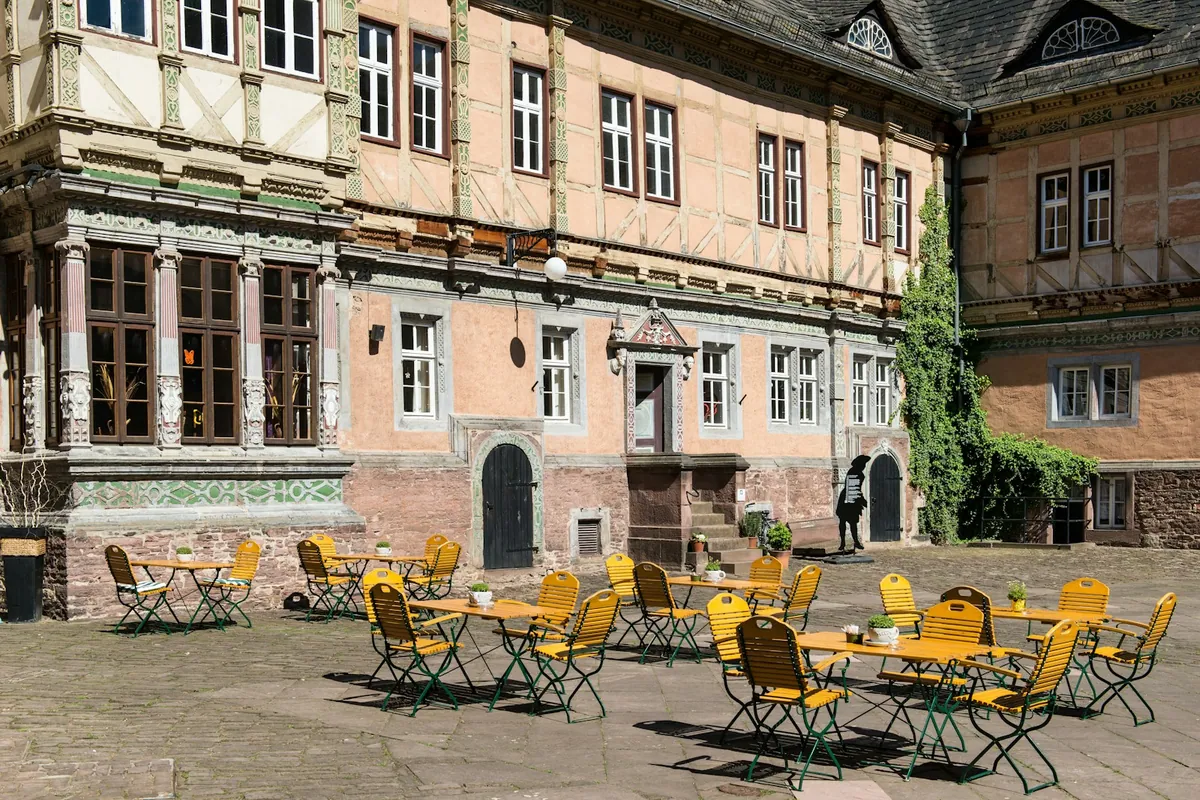 Outdoor café seating beside a historic European building