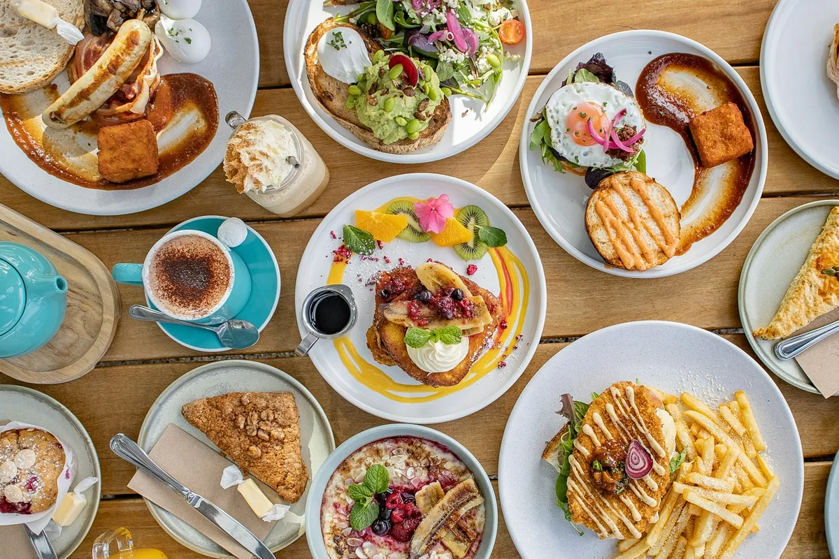 A café table filled with colourful brunch dishes