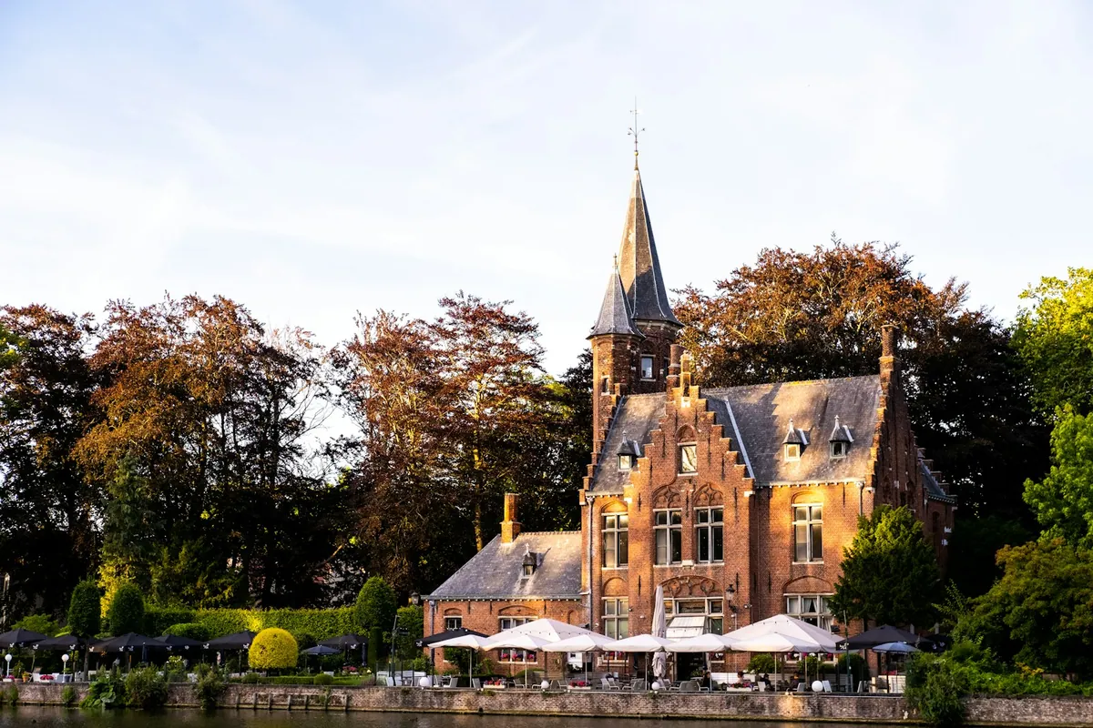 Historic buildings and greenery near Minnewater in Bruges