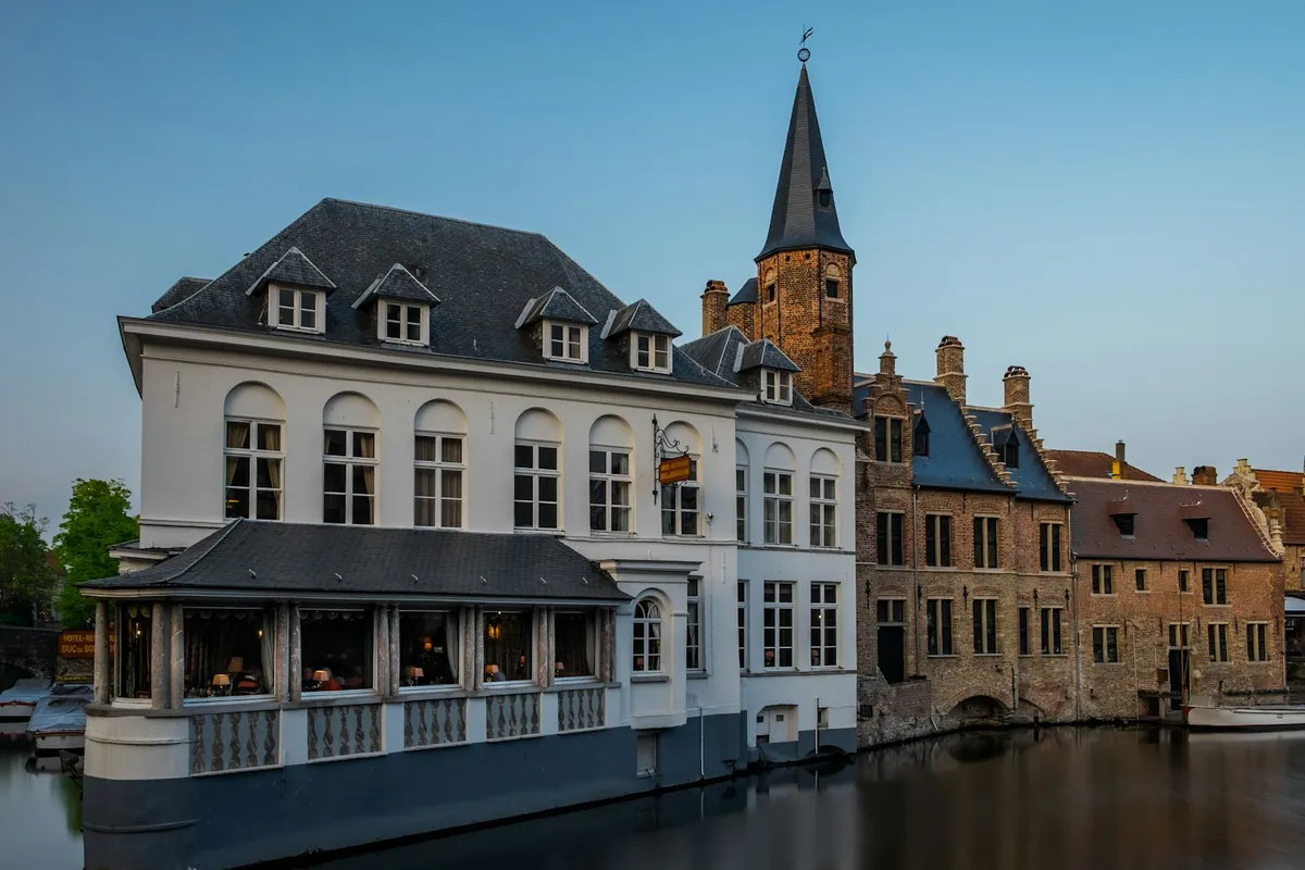 A refined white waterside house in historic Bruges